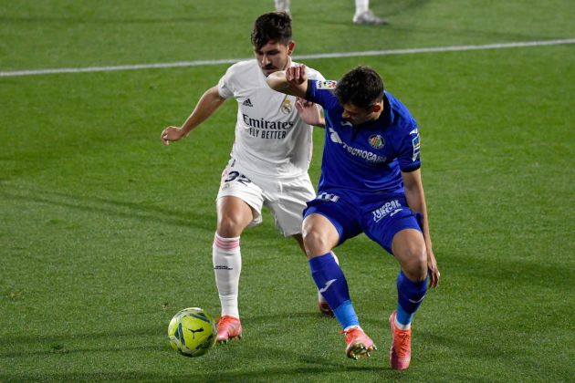 Real Madrid defender and Lazio linked Victor Chust (L) vies with Getafe's Turkish forward Enes Unal during the Spanish League football match between Getafe CF and Real Madrid CF at the Col. Alfonso Perez stadium in Getafe on April 18, 2021. (Photo by PIERRE-PHILIPPE MARCOU / AFP) (Photo by PIERRE-PHILIPPE MARCOU/AFP via Getty Images)