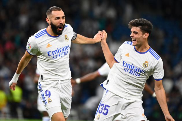 Real Madrid French forward Karim Benzema (L) celebrates scoring the opening goal with Real Madrid Spanish defender Miguel Gutierrez during the Spanish League footbal match between Real Madrid CF and Real Mallorca at the Santiago Bernabeu stadium in Madrid on September 22, 2021. (Photo by GABRIEL BOUYS / AFP) (Photo by GABRIEL BOUYS/AFP via Getty Images)