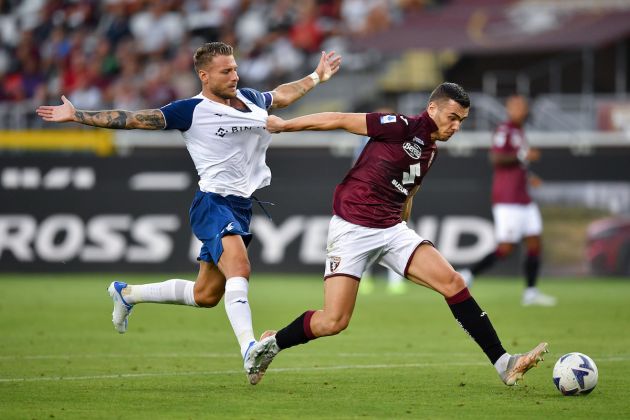 TURIN, ITALY - AUGUST 20: Alessandro Buongiorno of Torino FC battles for possession with Ciro Immobile of SS Lazio during the Serie A match between Torino FC and SS Lazio at Stadio Olimpico di Torino on August 20, 2022 in Turin, Italy. (Photo by Valerio Pennicino/Getty Images)