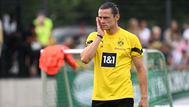 Dortmund defender Nico Schulz wipes his face during a training session at the club's training ground in Dortmund, western Germany on June 29, 2022. (Photo by Ina FASSBENDER / AFP) (Photo by INA FASSBENDER/AFP via Getty Images)