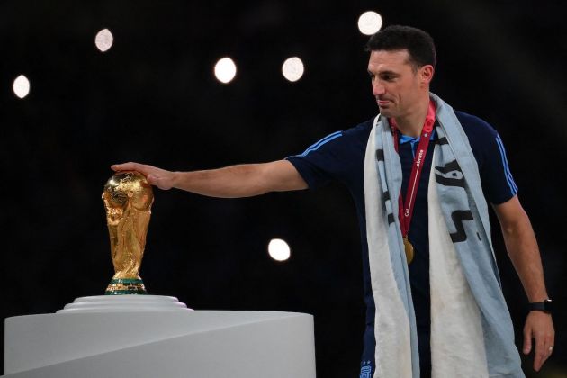 Argentina coach Lionel Scaloni touches the World Cup trophy as the team receives their gold medals during the Qatar 2022 World Cup trophy ceremony after the football final match between Argentina and France at Lusail Stadium in Lusail, north of Doha on December 18, 2022. - Argentina won in the penalty shoot-out. (Photo by FRANCK FIFE / AFP) (Photo by FRANCK FIFE/AFP via Getty Images)