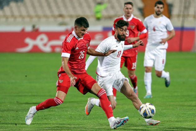 Iran Ali Gholizadeh (2nd-L) vies for the ball against Russia midfielder Daniil Khlusevich (L) during the friendly football match between Iran and Russia at Azadi Stadium in Tehran on March 23, 2023. (Photo by AFP) (Photo by -/AFP via Getty Images)