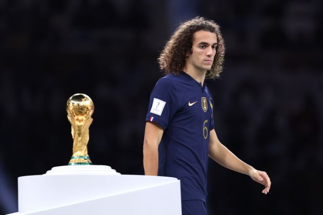 LUSAIL CITY, QATAR - DECEMBER 18: Matteo Guendouzi of France of France makes their way past the FIFA World Cup Qatar 2022 Winners Trophy following the FIFA World Cup Qatar 2022 Final match between Argentina and France at Lusail Stadium on December 18, 2022 in Lusail City, Qatar. (Photo by Clive Brunskill/Getty Images)