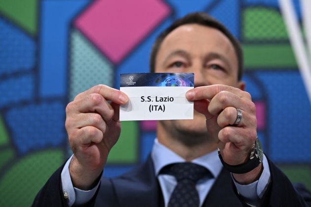 UEFA Champions League ambassador and British former football player, John Terry holds the paper slip of SS Lazio during the 2023-2024 UEFA Champions League football tournament round of 16 draw at the House of European Football in Nyon, on December 18, 2023. (Photo by Fabrice COFFRINI / AFP) (Photo by FABRICE COFFRINI/AFP via Getty Images)