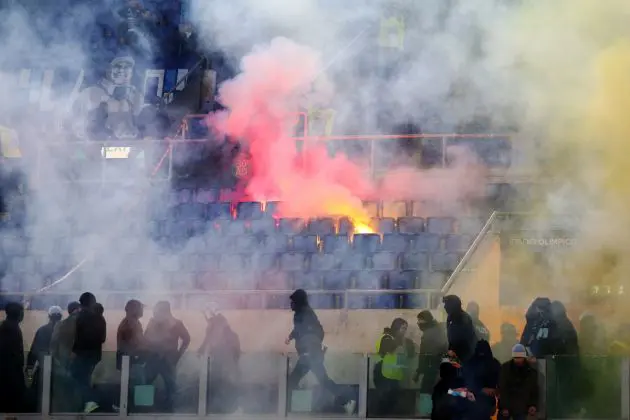 ROME, ITALY - JANUARY 10: A flare is thrown towards the SS Lazio fans in the stands prior to the Coppa Italia match between SS Lazio and AS Roma at Stadio Olimpico on January 10, 2024 in Rome, Italy. (Photo by Paolo Bruno/Getty Images)