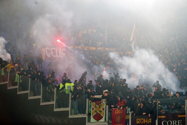 ROME, ITALY - JANUARY 10: Fans of AS Roma throw flares in the stands prior to the Coppa Italia match between SS Lazio and AS Roma at Stadio Olimpico on January 10, 2024 in Rome, Italy. (Photo by Paolo Bruno/Getty Images)